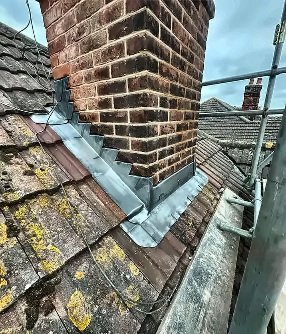 New stepped lead flashing dressed around a brick chimney stack in Cardiff
