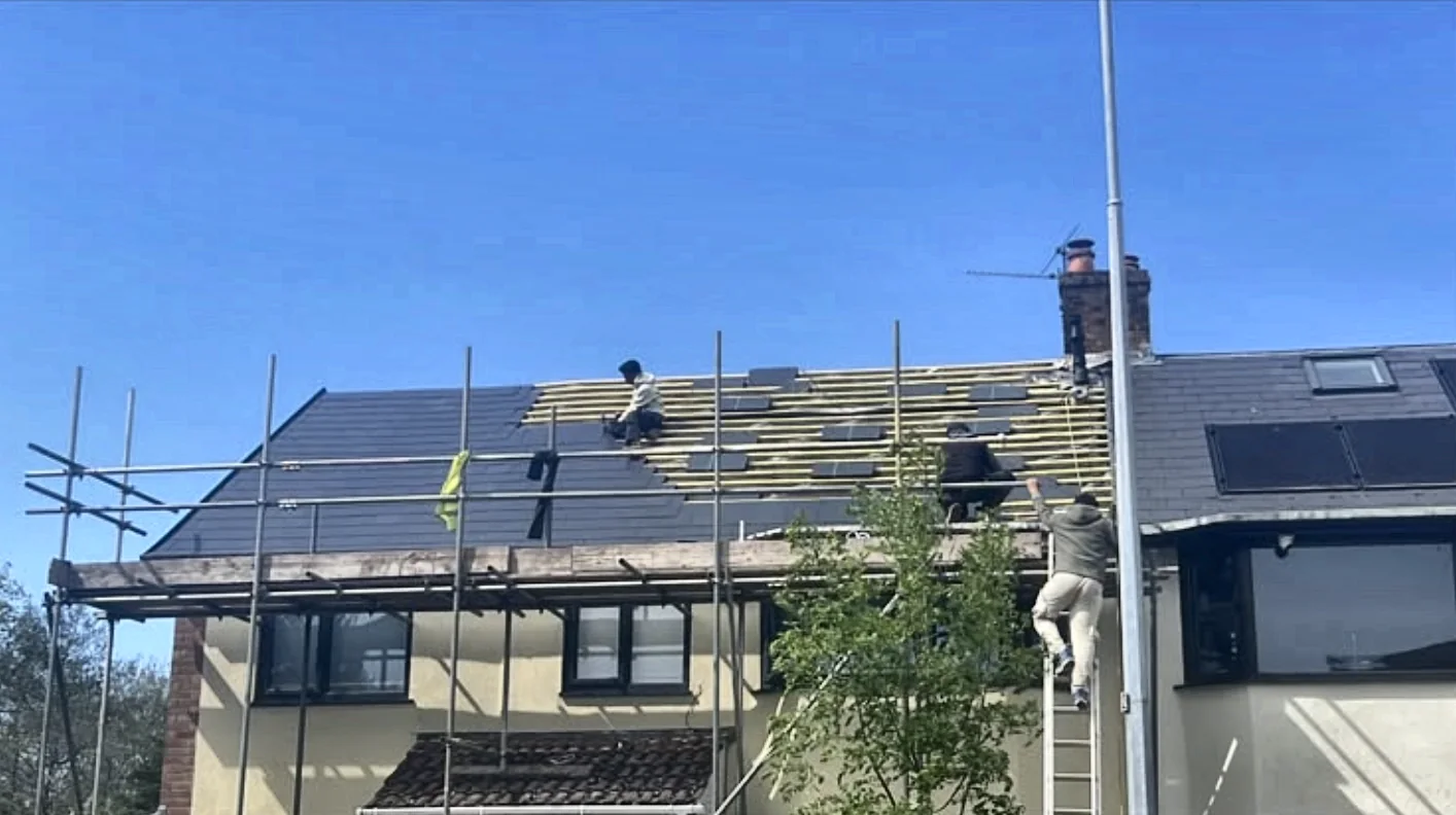 Quick Fit Roofing team re-roofing a scaffolded house in Cardiff